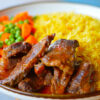 Picture showing Zimbokitchen ginger beef stew served with rice and steamed carrot and peas.