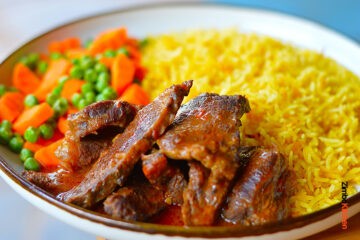 Picture showing Zimbokitchen ginger beef stew served with rice and steamed carrot and peas.